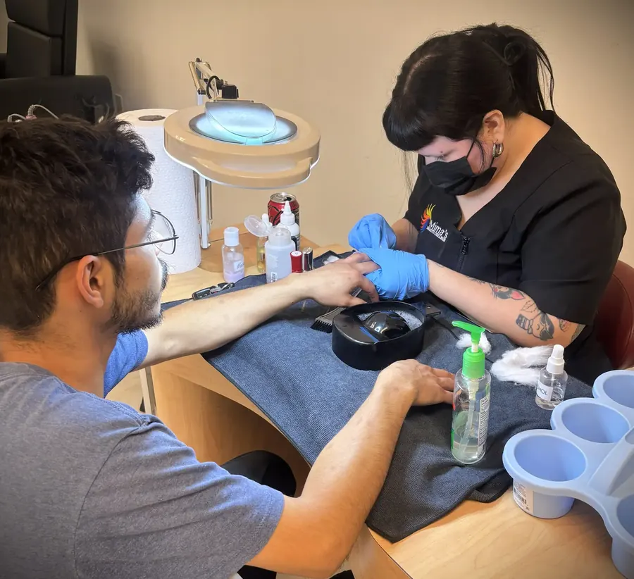 Nail technology student practicing a manicure